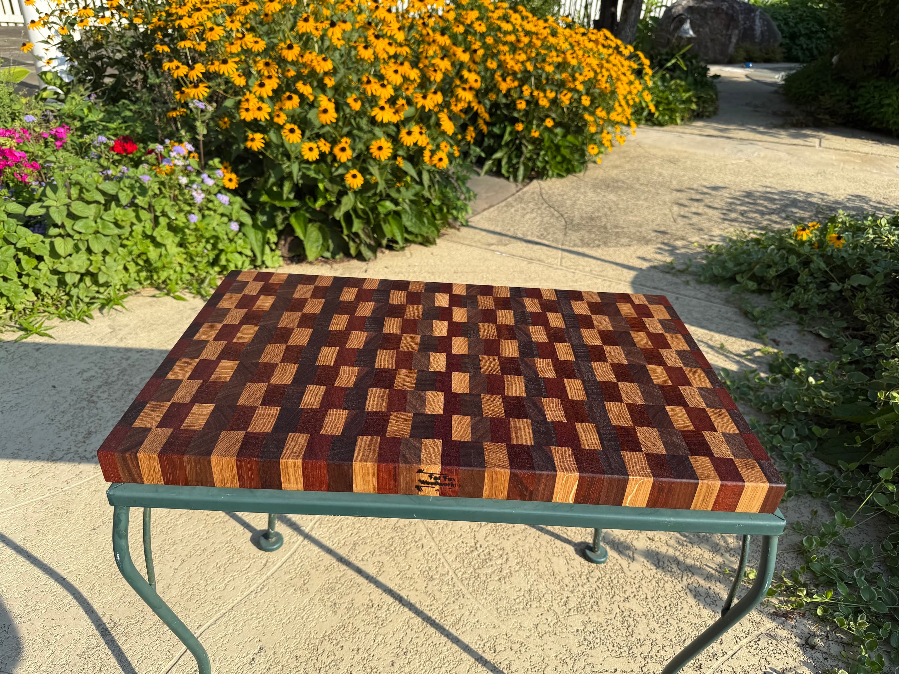 Richly patterned end-grain cutting board with the Fat Fox maker’s mark